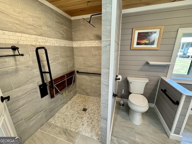 bathroom featuring tiled shower, wood ceiling, and toilet