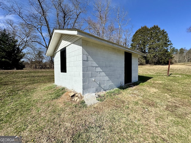 view of outbuilding with a yard