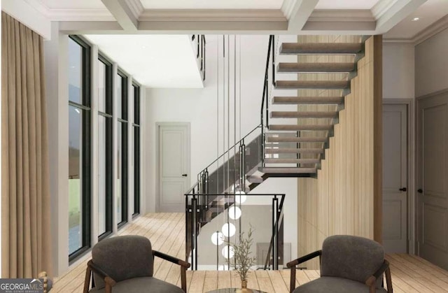 stairs featuring beam ceiling, crown molding, wood-type flooring, and a wall of windows