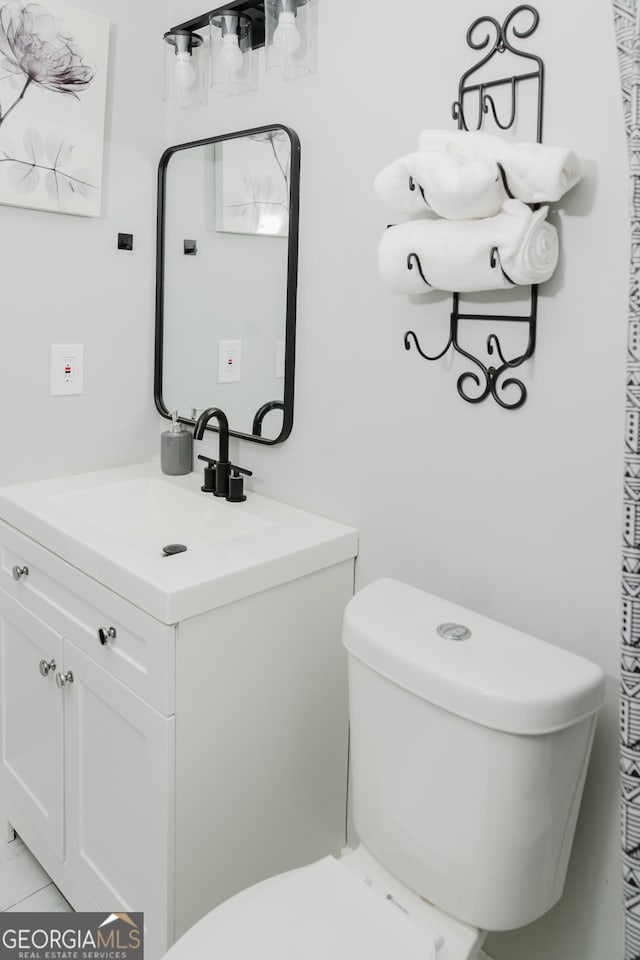 bathroom featuring vanity and toilet