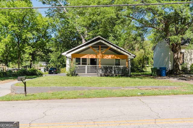 bungalow-style home with a front lawn