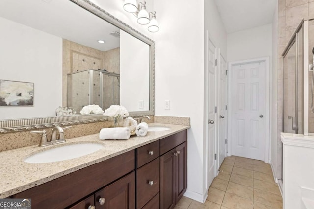 bathroom featuring vanity, tile patterned floors, and a shower with door