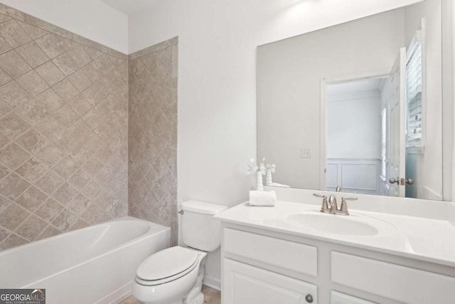 full bathroom featuring vanity, tiled shower / bath, and toilet