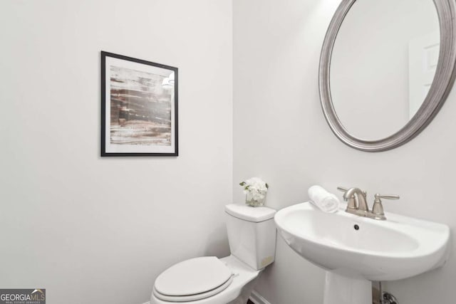 bathroom featuring toilet and sink