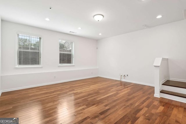 spare room featuring wood-type flooring