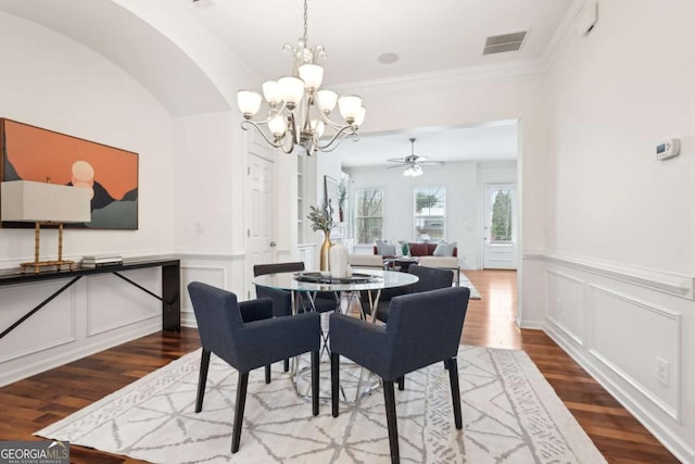 dining room with ornamental molding, a notable chandelier, and light hardwood / wood-style flooring