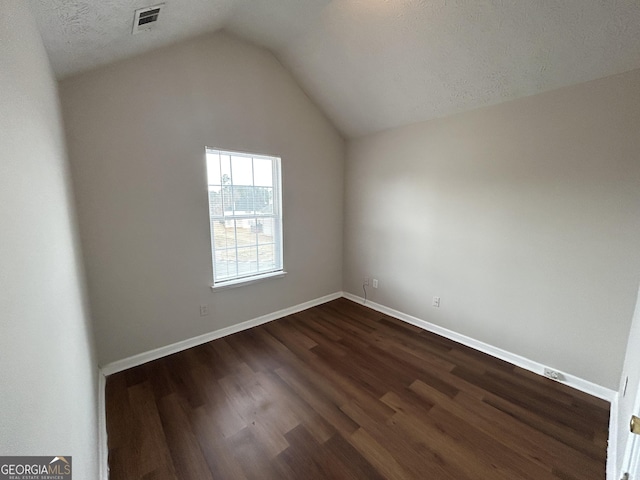 bonus room with dark hardwood / wood-style flooring and vaulted ceiling