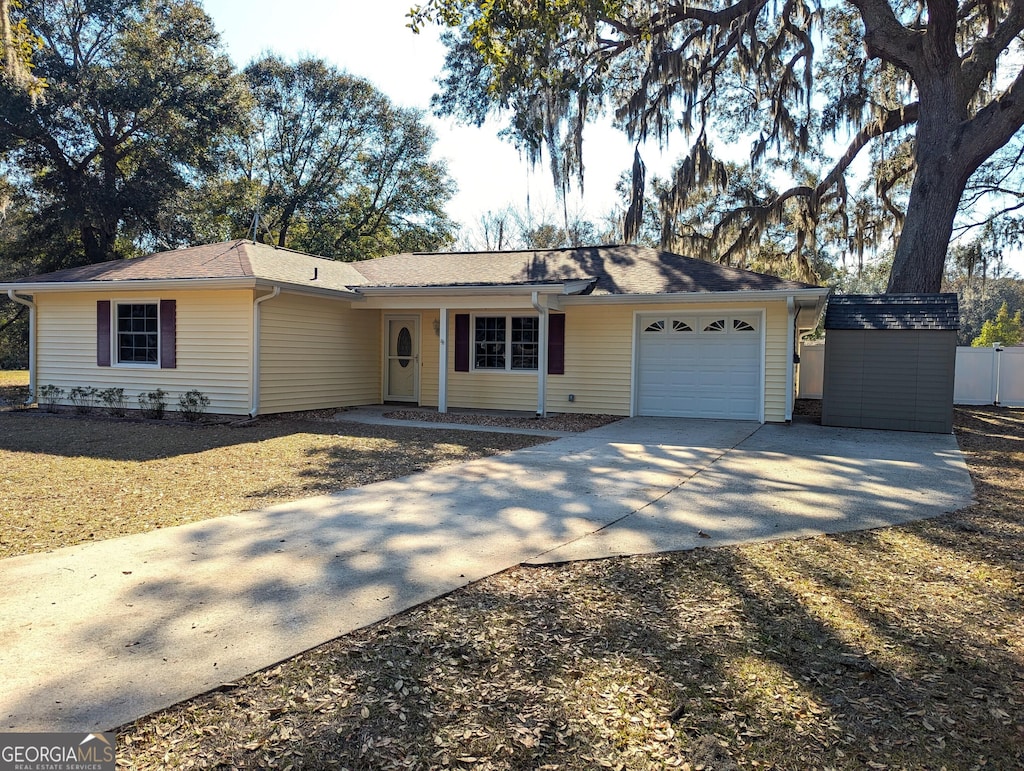 ranch-style house with a garage and a shed