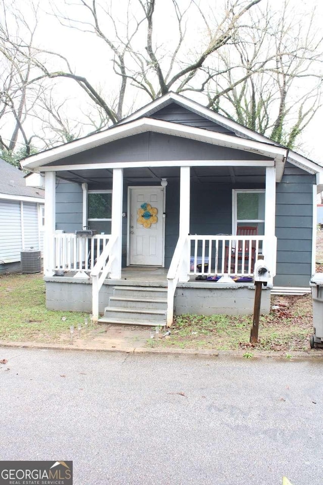 bungalow-style home featuring cooling unit and covered porch