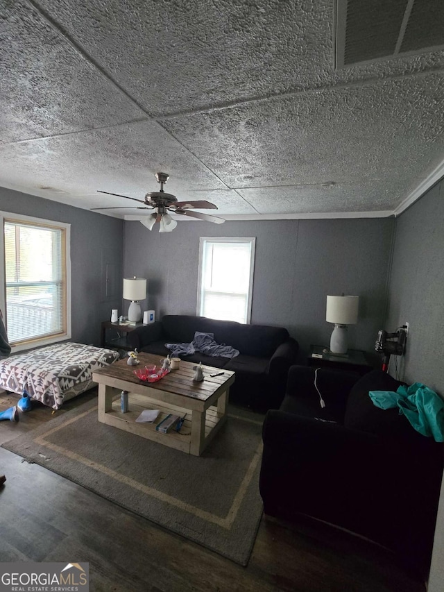 living room featuring wood-type flooring and ceiling fan