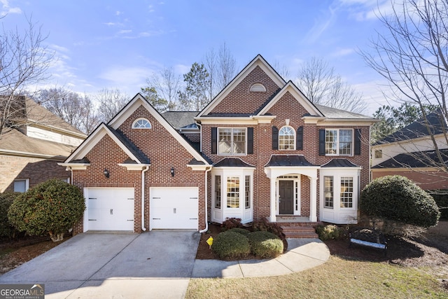 view of front facade with an attached garage, driveway, and brick siding