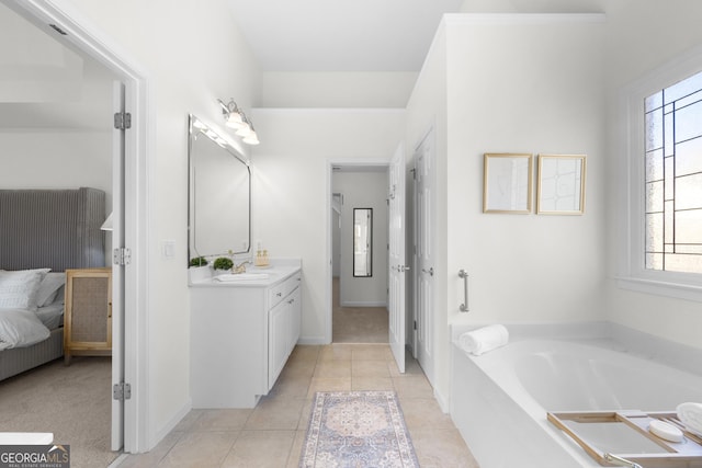 bathroom with tile patterned flooring, vanity, and a tub to relax in