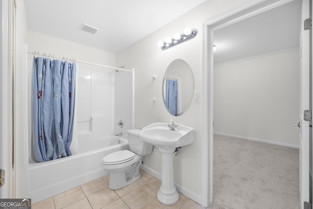 bathroom with tile patterned floors, toilet, and shower / bath combo with shower curtain