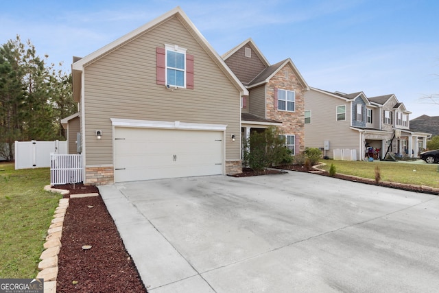 view of front of house with a garage and a front lawn