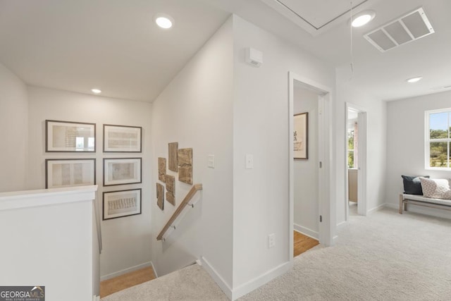 hall featuring light colored carpet