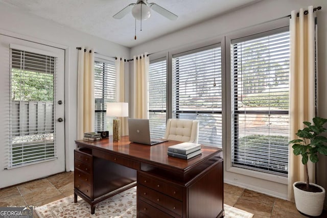 office space featuring ceiling fan and a textured ceiling