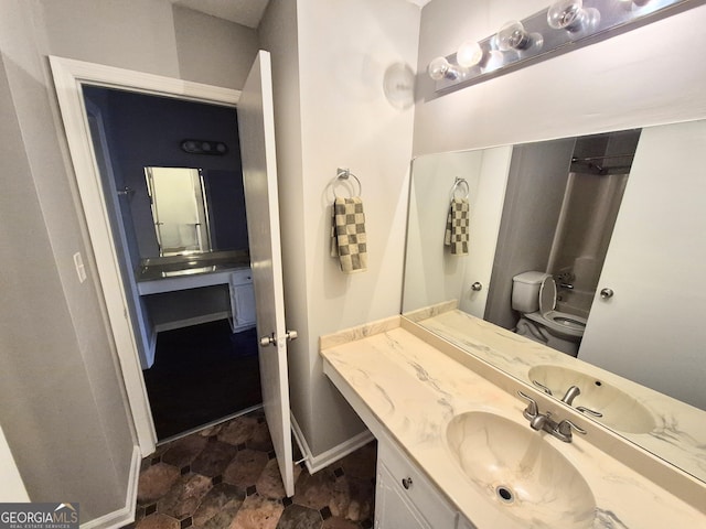 bathroom featuring vanity and toilet