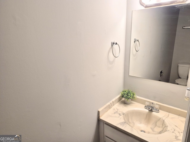 bathroom with vanity and toilet