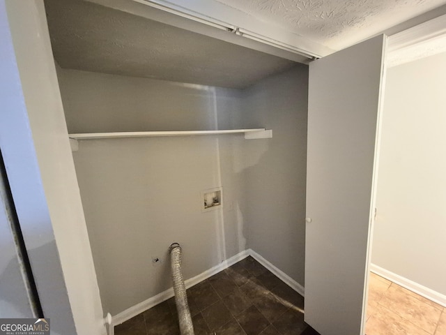 laundry room featuring washer hookup and a textured ceiling