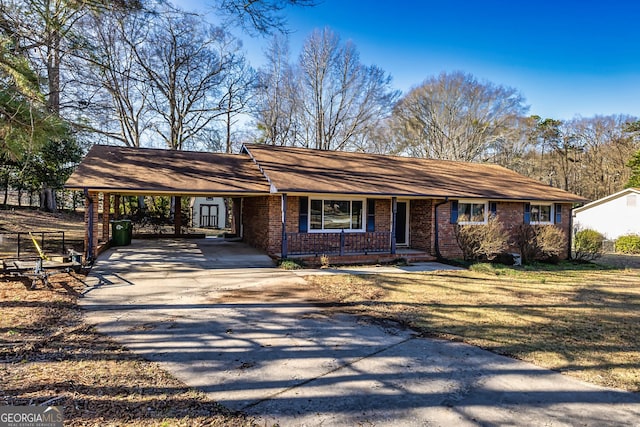 ranch-style home featuring a carport and a porch