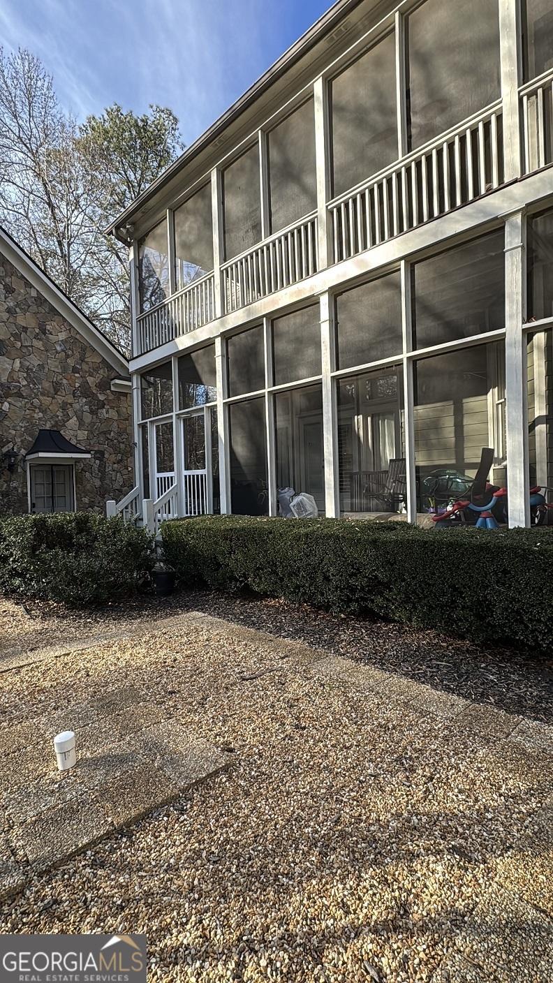 back of property with a sunroom