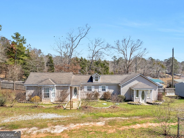 view of front of house featuring a front yard and fence