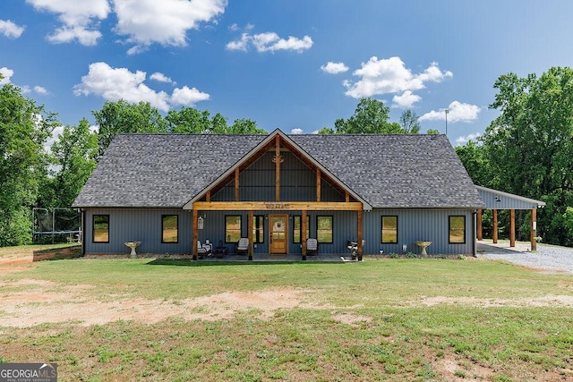 4059 Wildcat Bridge Rd, Royston, GA 30662 - rear view of property with a trampoline, a shingled roof, a yard, and a porch