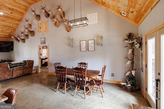 dining area featuring high vaulted ceiling and wood ceiling