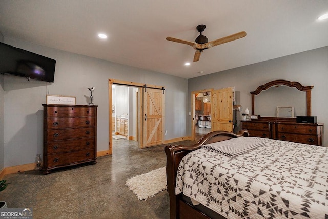 bedroom featuring ensuite bath, a barn door, and ceiling fan