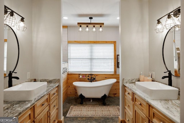 bathroom with vanity and a tub