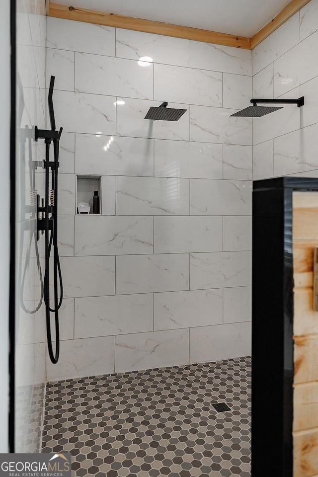 bathroom with a tile shower