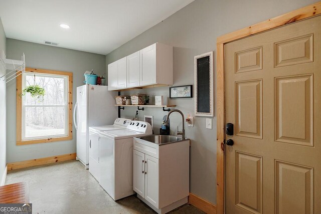 4059 Wildcat Bridge Rd, Royston, GA 30662 - washroom featuring visible vents, baseboards, washing machine and clothes dryer, a sink, and cabinet space