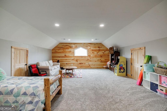 carpeted bedroom featuring wooden walls and vaulted ceiling