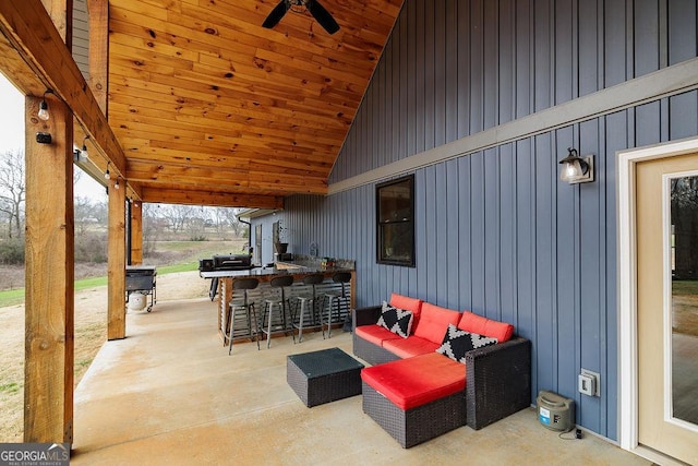 view of patio featuring a bar and ceiling fan