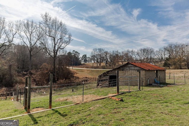 view of yard with a rural view and an outdoor structure