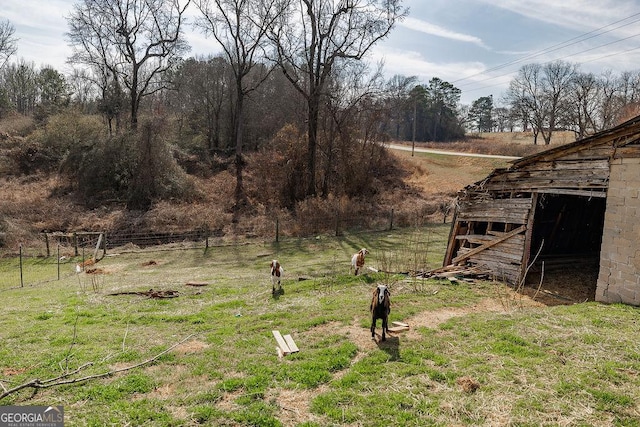 view of yard with a rural view and an outdoor structure