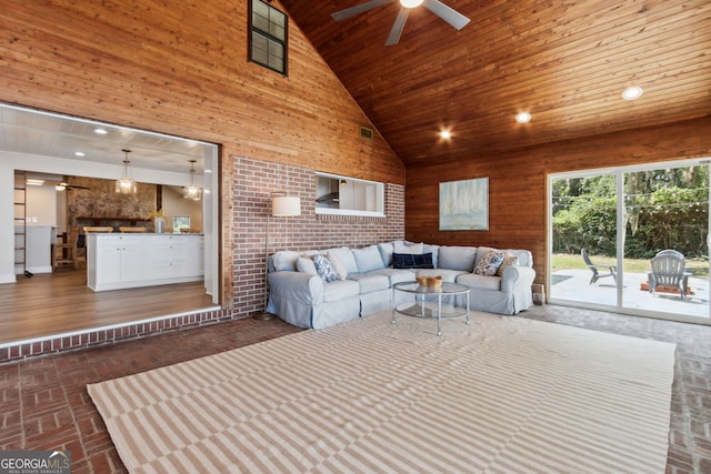 1142 New Point Peter Rd, Saint Marys, GA 31558 - living room with wooden ceiling, a ceiling fan, high vaulted ceiling, wood walls, and brick patterned flooring