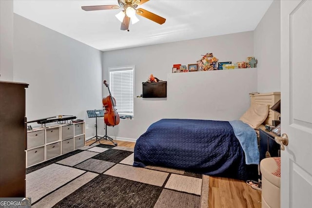 bedroom with ceiling fan and light wood-type flooring