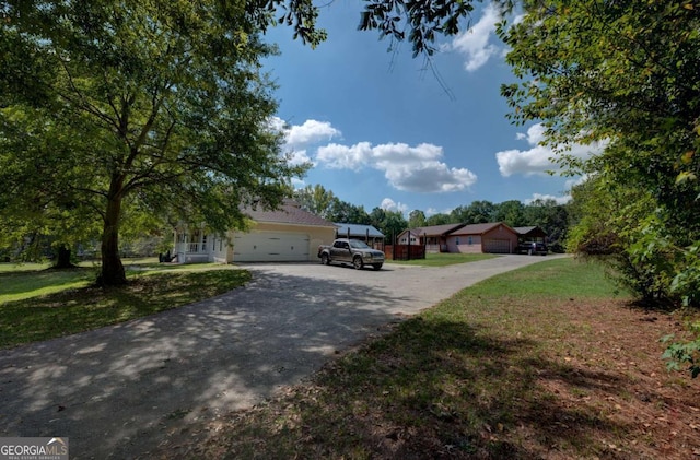 view of front of property featuring a garage and a front yard