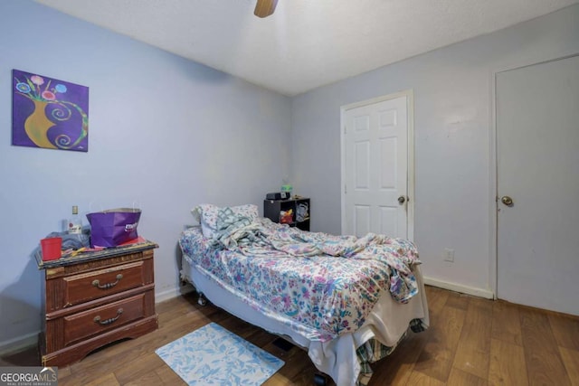 bedroom with wood-type flooring and ceiling fan