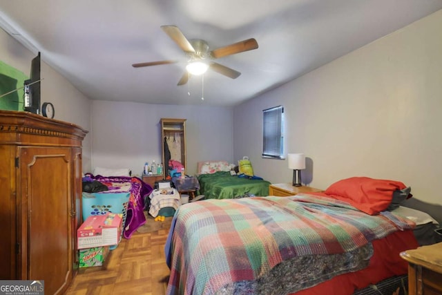 bedroom featuring ceiling fan and light parquet flooring