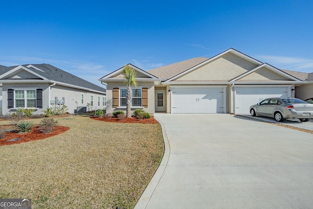 ranch-style house featuring a garage and a front lawn