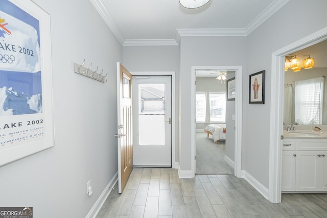 entryway featuring crown molding and sink