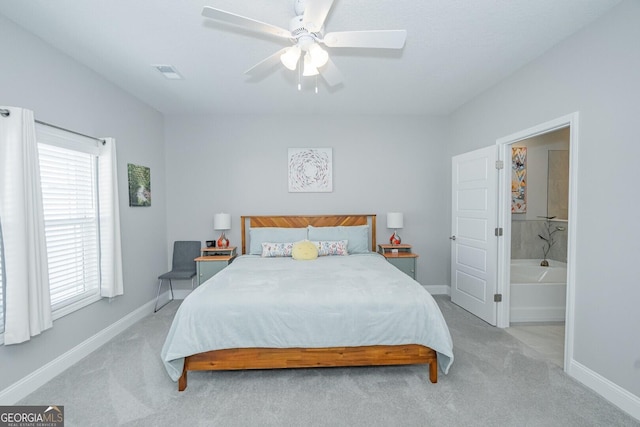 carpeted bedroom featuring ceiling fan and ensuite bathroom