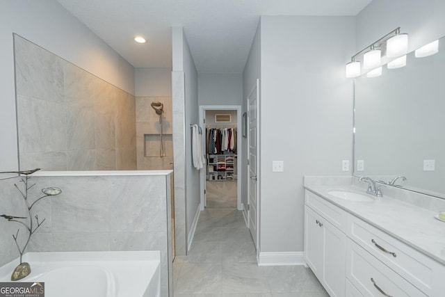 bathroom with tile patterned flooring, vanity, and separate shower and tub