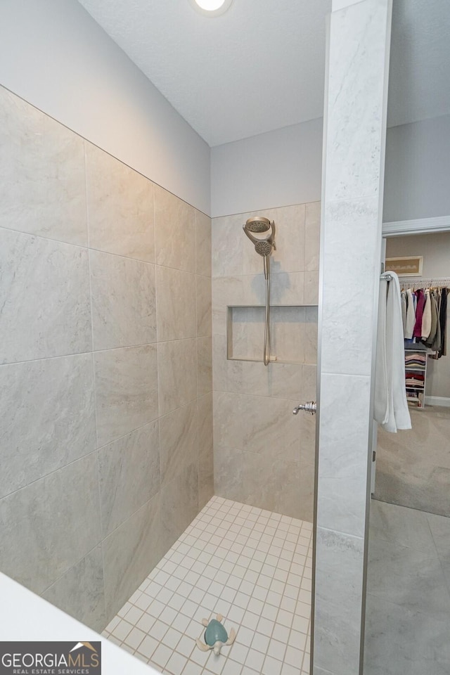 bathroom with tiled shower