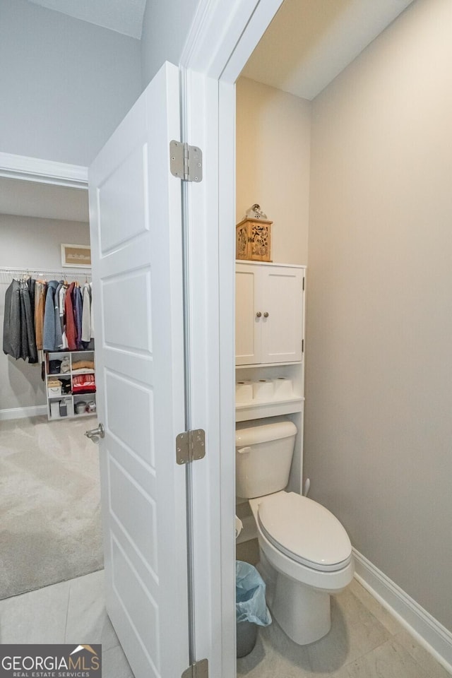 bathroom featuring toilet and tile patterned flooring