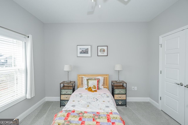 bedroom featuring light carpet and ceiling fan