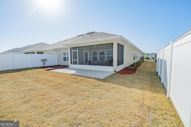 back of house with a yard, a patio area, a sunroom, and ceiling fan