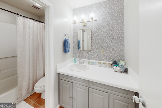 full bathroom with vanity, tile patterned floors, toilet, and shower / tub combo with curtain